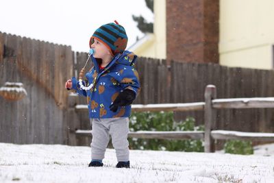 Full length of cute boy in snow