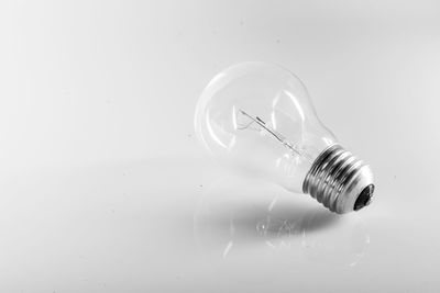 Close-up of light bulb over white background