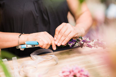 Midsection of bride holding bouquet