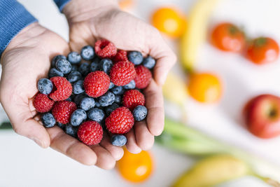 Close-up of hand holding strawberries