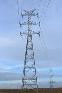 Low angle view of electricity pylon against sky