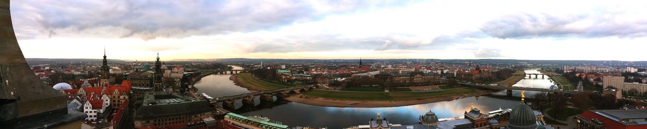 Cityscape against cloudy sky