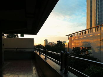 Bridge in city against sky during sunset