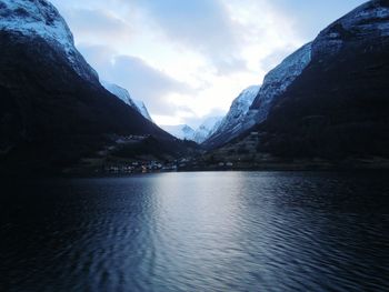 Scenic view of lake against cloudy sky