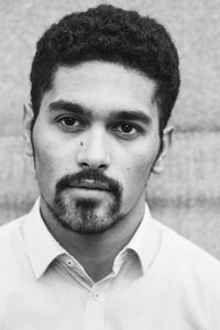 Close-up portrait of young man against wall