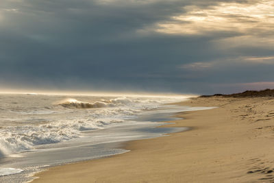 Scenic view of beach against sky during sunset