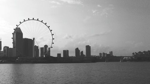 City by river against sky