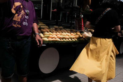 Midsection of man standing at market stall