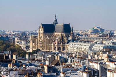 Saint-eustache church amidst cityscape against clear sky