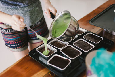 Midsection of woman preparing sweet food at home