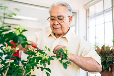 Portrait of man holding flower bouquet