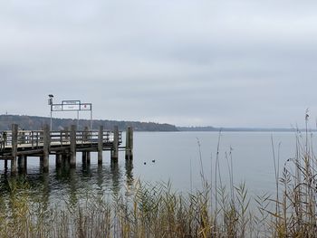 Pier on lake against sky