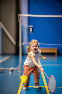 Portrait of young woman exercising at gym