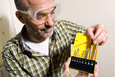 Close-up of man holding eyeglasses