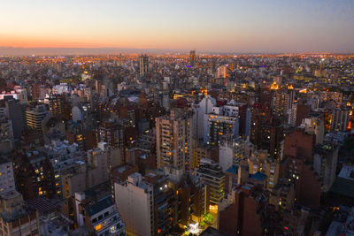 High angle view of illuminated city buildings against sky