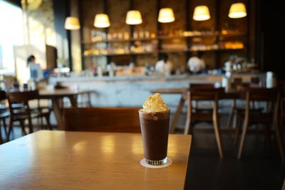 Close-up of coffee served on table at cafe