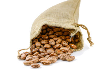 Close-up of roasted coffee beans against white background