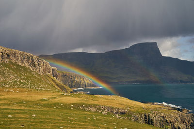 Rainbow over mountain against sky