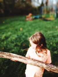 Girl enjoying backyard sticks