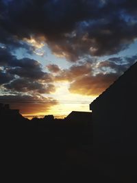 Low angle view of silhouette buildings against sky during sunset