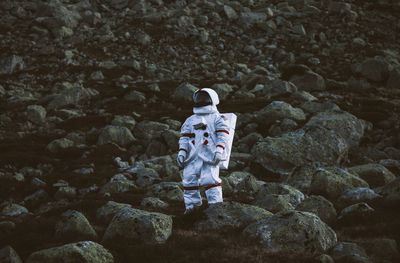 Full length of astronaut standing against sky