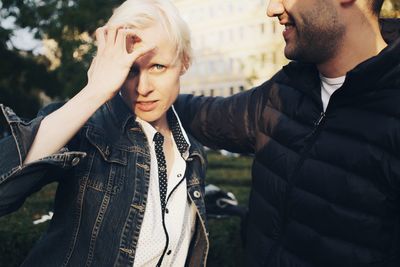 Portrait of woman standing by man in park