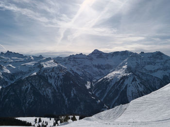 Scenic view of snowcapped mountains against sky