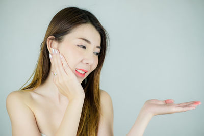 Portrait of a beautiful young woman over white background