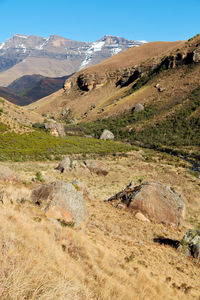 Scenic view of land and mountains against sky