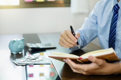 Midsection of doctor working on table