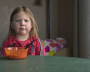 Portrait of cute girl with ice cream in bowl