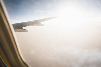 Close-up of airplane wing against sky