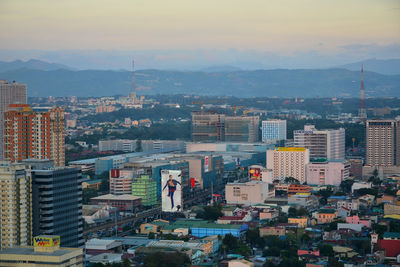 High angle view of buildings in city against sky during sunset