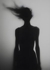 Low angle view of woman standing against wall