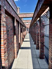 Footpath amidst buildings against sky