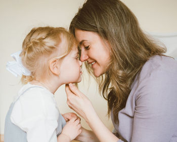 Mother and daughter sitting at home