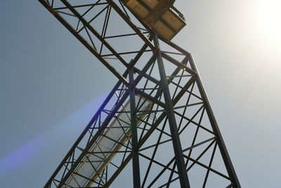 Low angle view of communications tower against sky