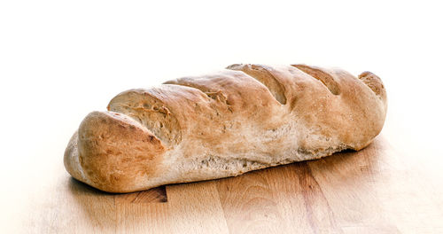 Close-up of fresh bread against white background