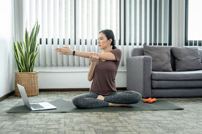 Young woman exercising at home