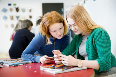 Teenage girls using smartphone