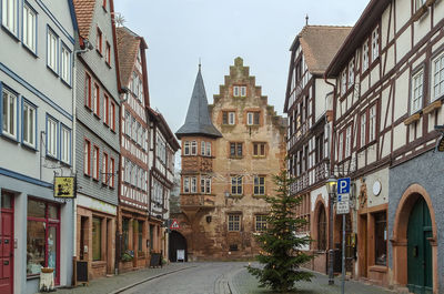 Street amidst buildings against sky