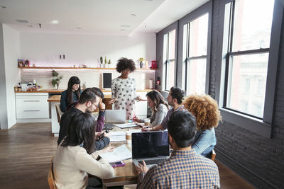 Colleagues planning at table in office