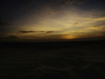 Scenic view of beach against sky during sunset