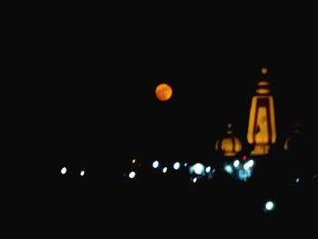 Low angle view of illuminated moon at night