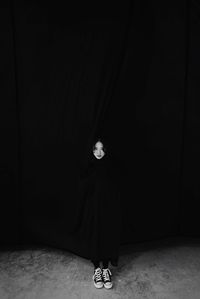 Full length of a man standing in the dark