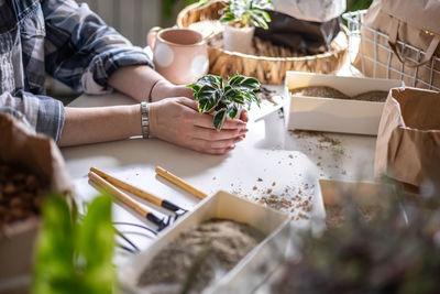 High angle view of woman holding food on table