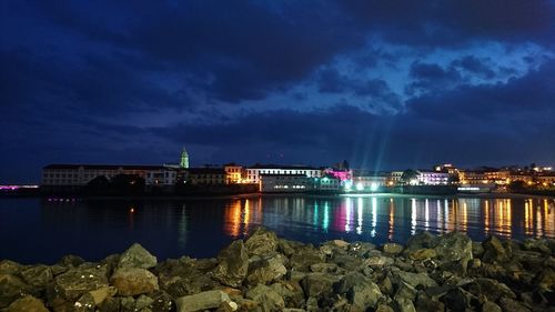 Illuminated city at waterfront