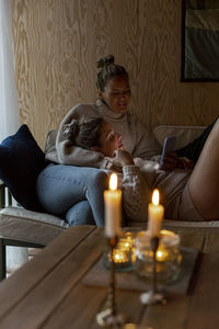 Female friends sitting on sofa