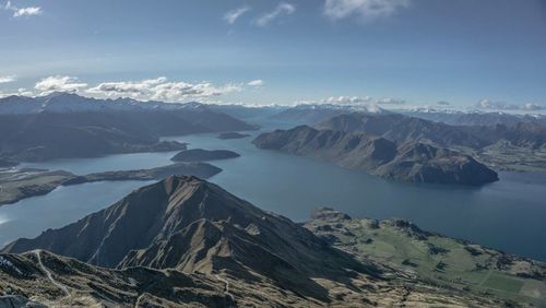 Scenic view of sea and mountains against sky