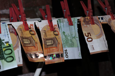 Close-up of paper currencies hanging on rack